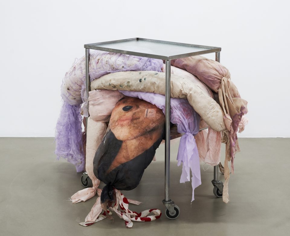 Mimosa Echard, Sisters, 2020. Kitchen trolley aluminium glass, Calendula, skin capsule, Lotus seeds, Clitoria flowers, fern, Ginseng, Gardenia, glitter, synthetic foam, condom packaging, textile printing, fabric, vinyl glue. 82 x 120 x 100 cm. Courtesy of the artist and Chantal Crousel Gallery